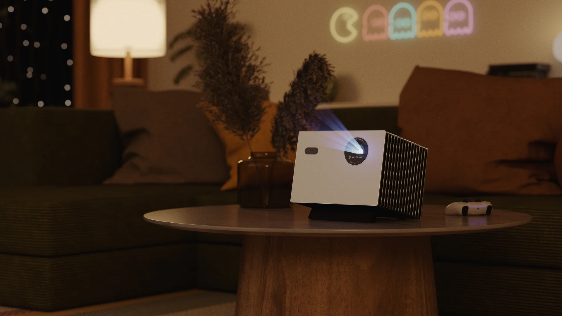 Valerion StreamMaster Plus 2 white-fronted projector with finned side on a coffee table in a living room, projecting onto the wall
